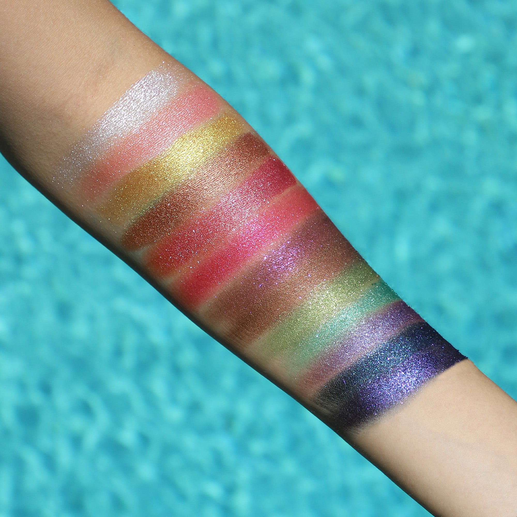 Official unlabeled arm swatches showing the real palette's shimmer